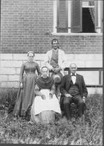 SA0209 - Four people--Jane Sutton, Sarah Wickenford, Napoleon Brown, and Stephen Boiusseau--in front of the office. Identified on reverse;, Winterthur Shaker Photograph and Post Card Collection 1851 to 1921c
